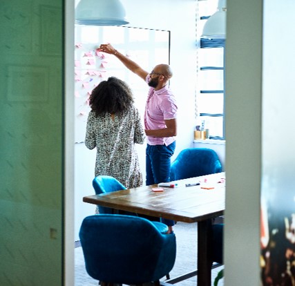 people working together at a whiteboard